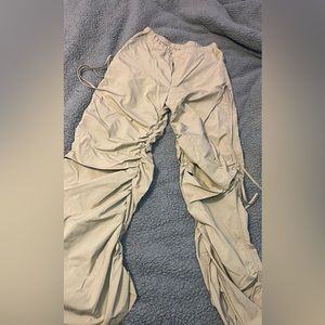 Tan trousers with adjustable ties at the sides. Worn only once. Still brand new!
